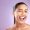 Woman, tongue and wink for funny skincare wellness or face dermatology beauty in purple studio back.